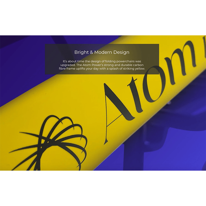 Atom Power Power Chair - Yellow folding power chair with 'Atom' branding on a blue background
