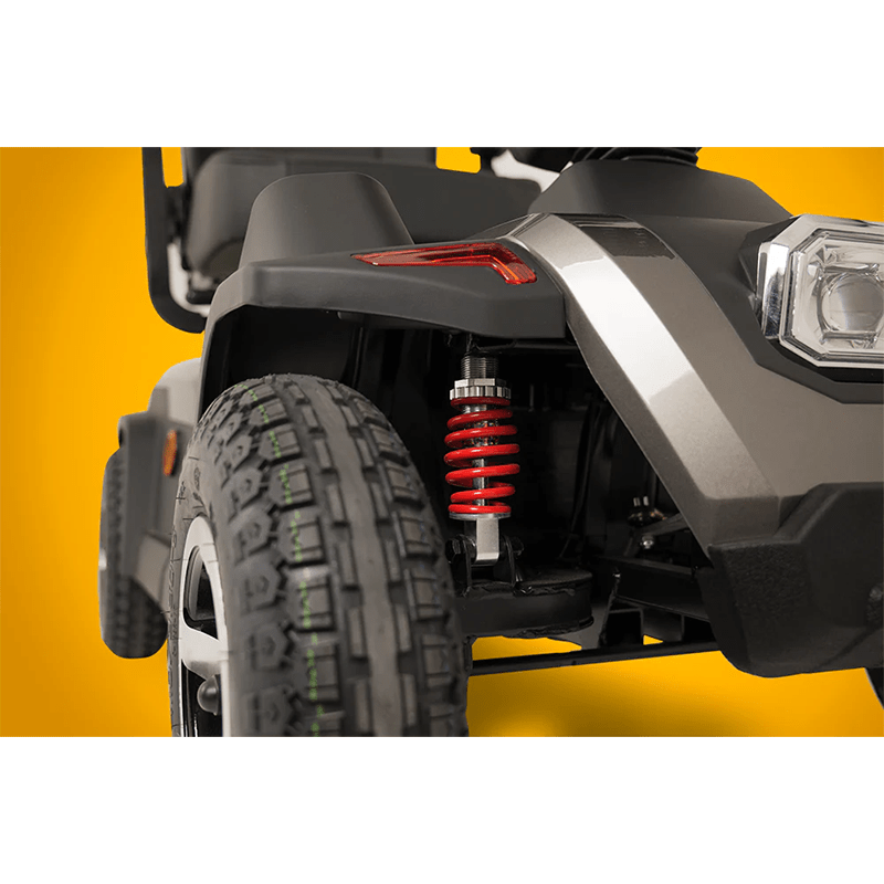 Scooterpac Savvy 8 Plus - Close-up of a vehicle's front wheel and suspension system on a yellow background